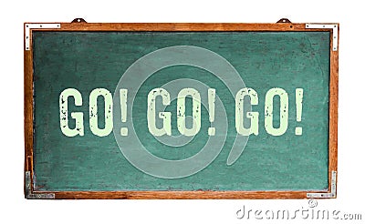 `Go! Go! Go!â€ motivational text word message written on a wide green old grungy vintage wooden chalkboard Stock Photo